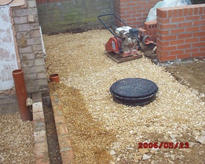 patio area nicely levelled - you can see where the new rainwater drain runs down the side of the wall